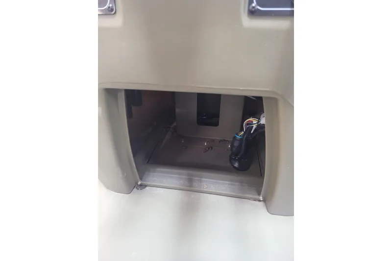 Slide: The Image of 2026 Tracker Grizzly 1860 CC console interior with wiring visible. - 6