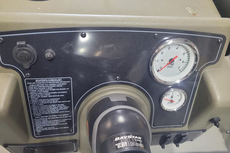 Slide: The Image of Dashboard of 2026 Tracker Grizzly 1860 CC boat with gauges and boater's checklist. - 8