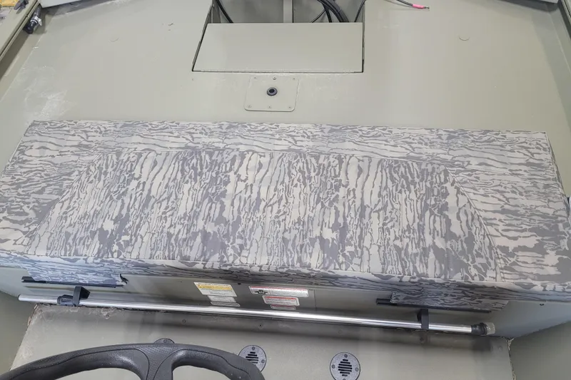 Slide: The Image of 2026 Tracker Grizzly 1860 CC boat interior with camouflage-patterned seat and steering wheel. - 9