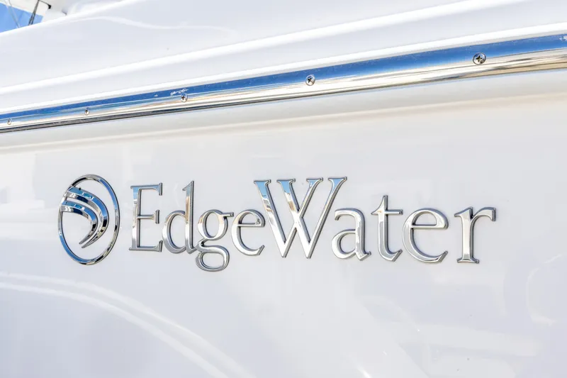 Slide: The Image of Edgewater 285CC 2026 boat logo on white surface, showcasing sleek design. - 11