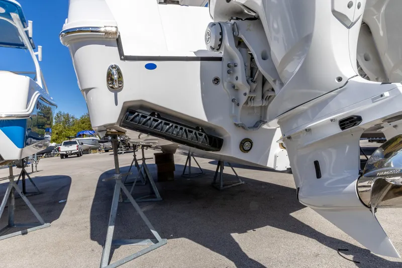 Slide: The Image of 2026 Edgewater 285CC boat on stands, showcasing its sleek design and powerful engine. - 12