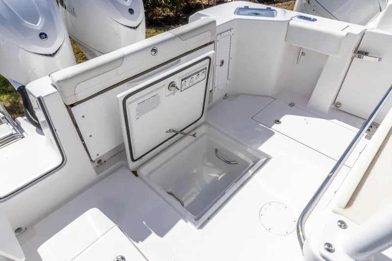 Slide: The Image of 2026 Edgewater 285CC boat interior with storage compartments and sleek design. - 17