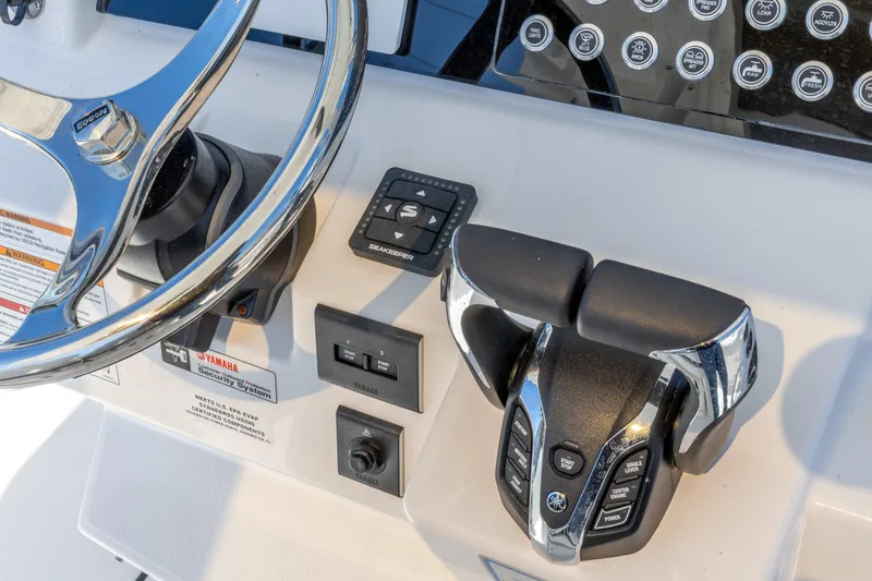 Slide: The Image of Edgewater 285CC 2026 boat dashboard with steering wheel and control panel. - 18