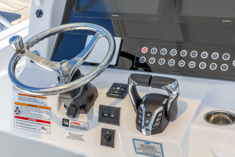 Slide: The Image of 2026 Edgewater 285CC boat dashboard with steering wheel and control panel. - 19