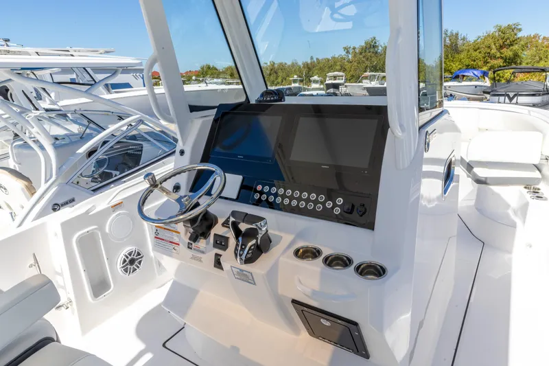 Slide: The Image of Edgewater 285CC 2026 boat cockpit with modern steering and control panel. - 2
