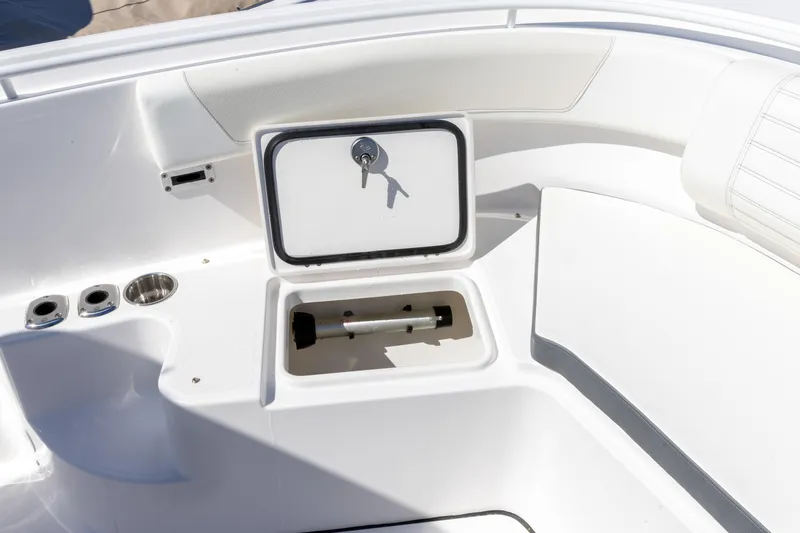 Slide: The Image of 2026 Edgewater 285CC boat interior with storage compartment and cup holders. - 24