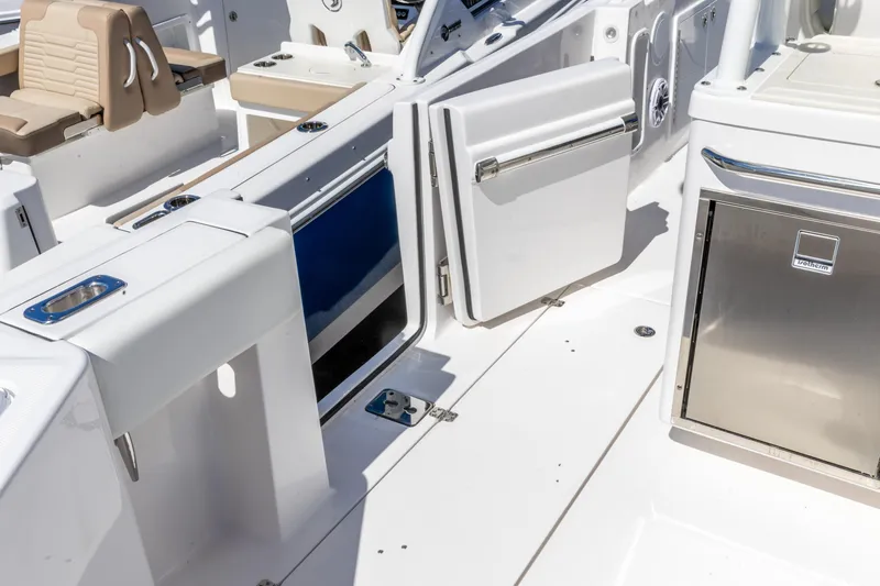 Slide: The Image of 2026 Edgewater 285CC boat interior with open storage compartments and seating. - 4