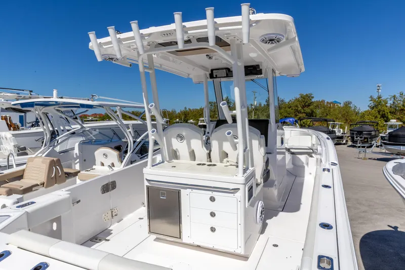 Slide: The Image of 2026 Edgewater 285CC boat with sleek design and modern features, docked under clear blue sky. - 5