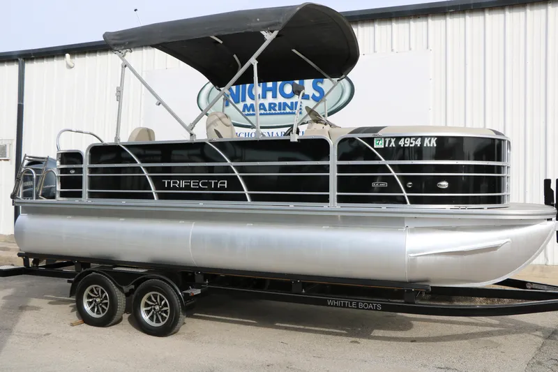 The Image of 2021 Trifecta 22 RFC pontoon boat on trailer, black and silver design. - 1