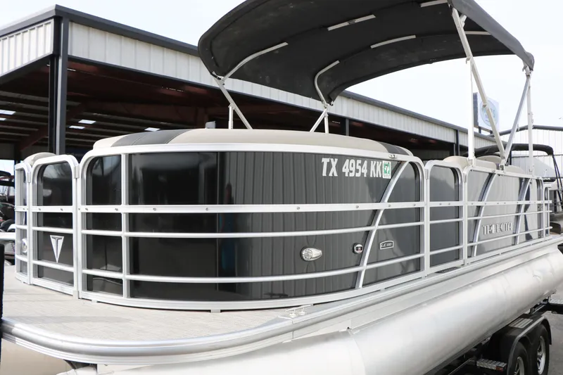 Slide: The Image of 2021 Trifecta 22 RFC pontoon boat with canopy, docked in a marina. - 15