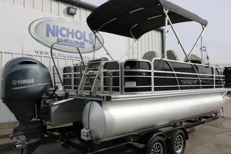 Slide: The Image of 2021 Trifecta 22 RFC pontoon boat with Yamaha engine at Nichols Marine dealership. - 2