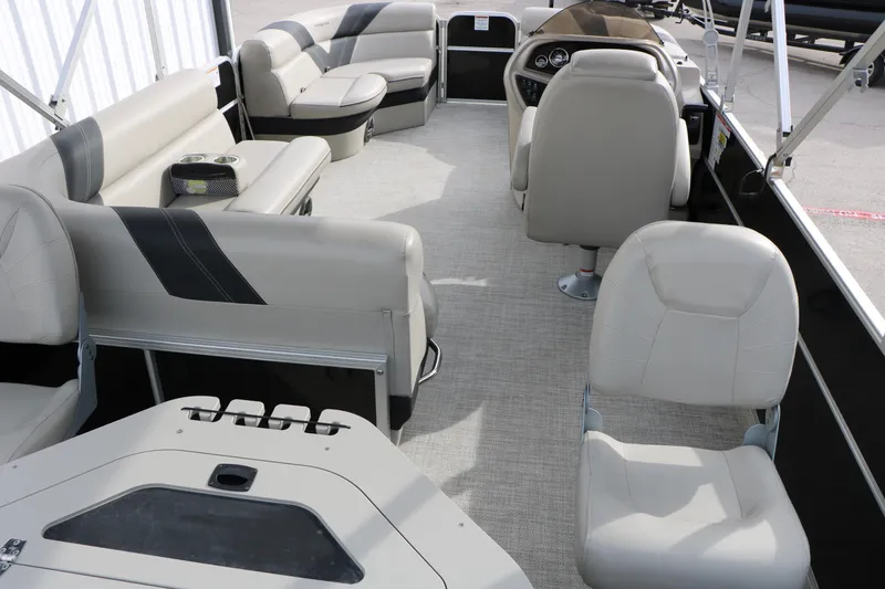 Slide: The Image of 2021 Trifecta 22 RFC pontoon boat interior with beige seating and modern design. - 23