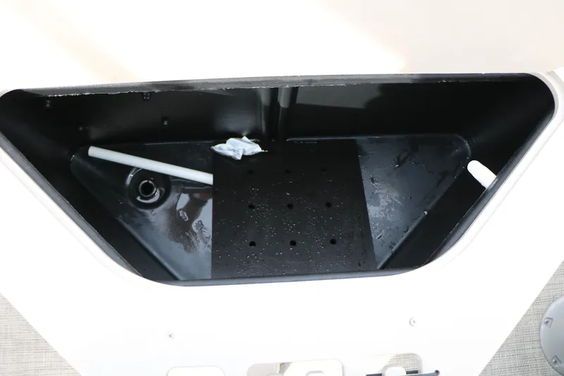Slide: The Image of Storage compartment of 2021 Trifecta 22 RFC boat, featuring drainage and utility space. - 33