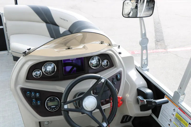 Slide: The Image of 2021 Trifecta 22 RFC boat dashboard with steering wheel and control panel. - 35