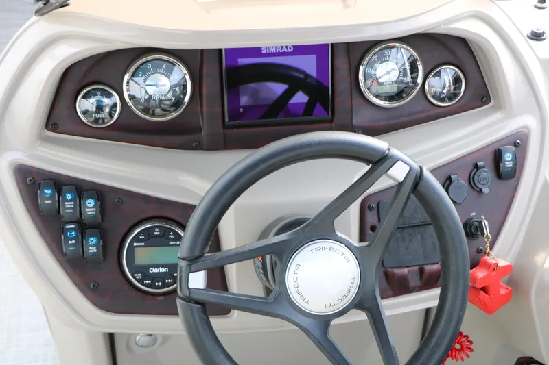 Slide: The Image of 2021 Trifecta 22 RFC boat dashboard with steering wheel and control panel. - 36