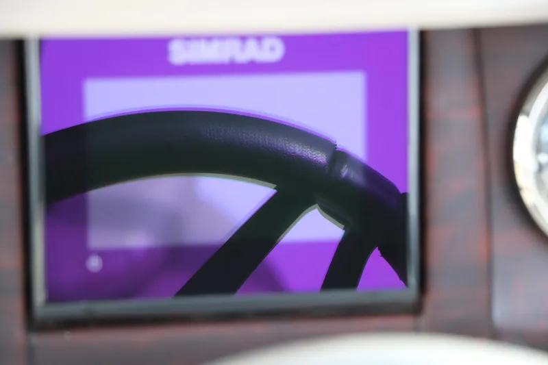 Slide: The Image of Steering wheel of 2021 Trifecta 22 RFC boat with Simrad display. - 37