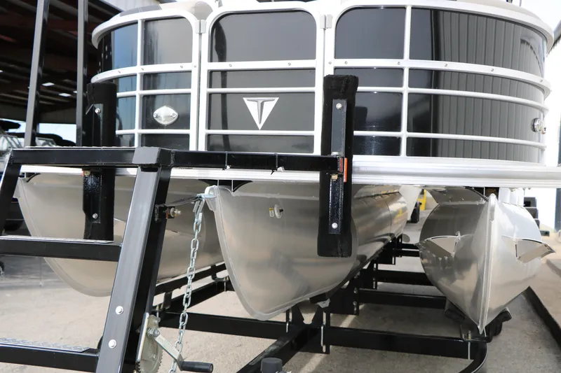 Slide: The Image of 2021 Trifecta 22 RFC pontoon boat on trailer, showcasing sleek aluminum pontoons. - 5