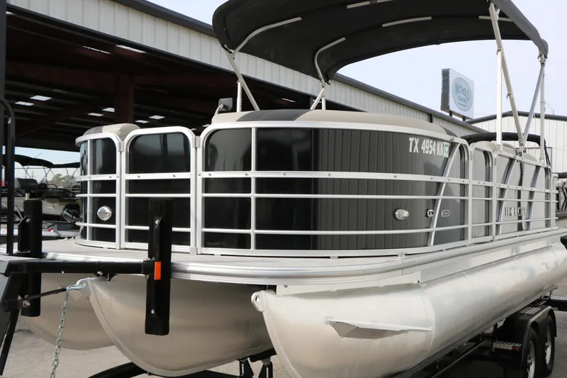 Slide: The Image of 2021 Trifecta 22 RFC pontoon boat with canopy, docked in a marina setting. - 6