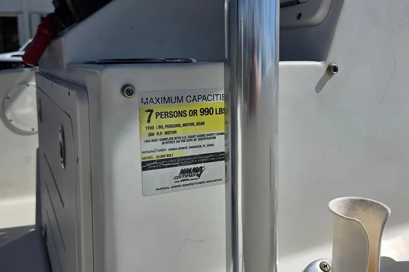 Slide: The Image of 2008 Hydra-Sports Bay Bolt 23 boat capacity label, maximum 7 persons or 990 lbs. - 16