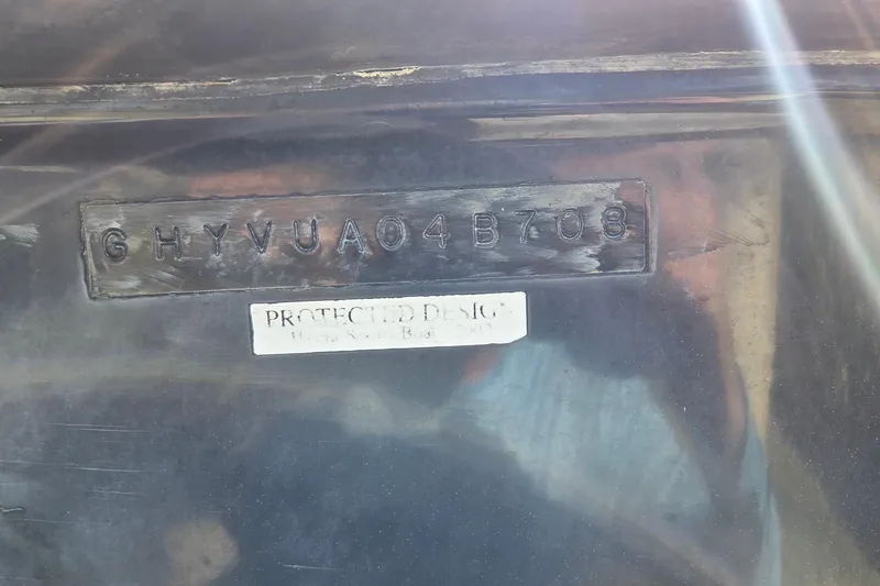 Slide: The Image of 2008 Hydra-Sports Bay Bolt 23 hull identification number with protective design label. - 18