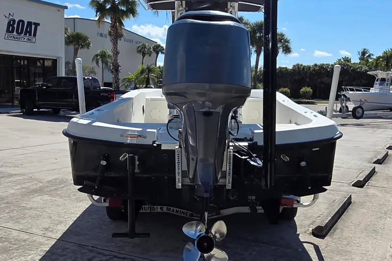 Slide: The Image of 2008 Hydra-Sports Bay Bolt 23 boat with outboard motor, parked at a marina. - 2