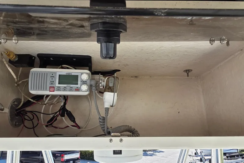 Slide: The Image of 2008 Hydra-Sports Bay Bolt 23 boat electronics compartment with Uniden marine radio and wiring. - 5