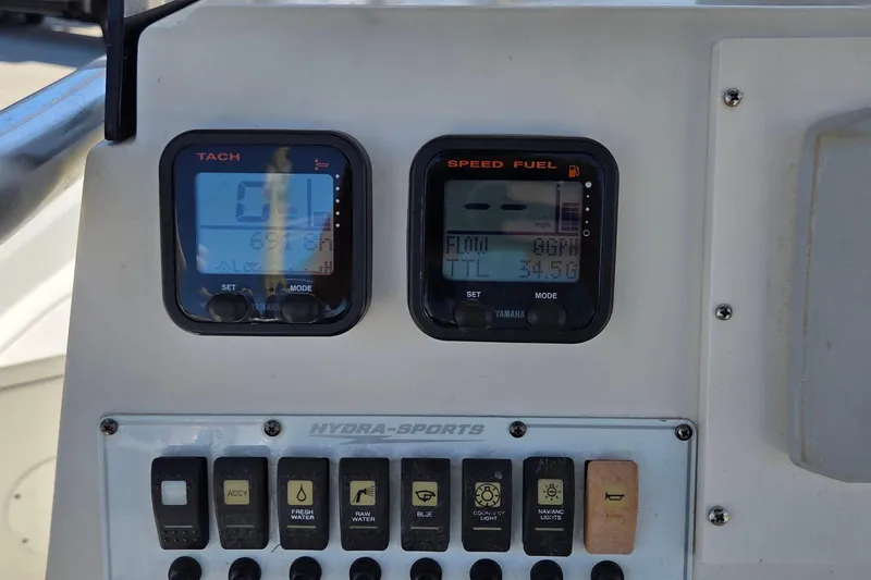 Slide: The Image of Control panel of a 2008 Hydra-Sports Bay Bolt 23 boat with gauges and switches. - 7