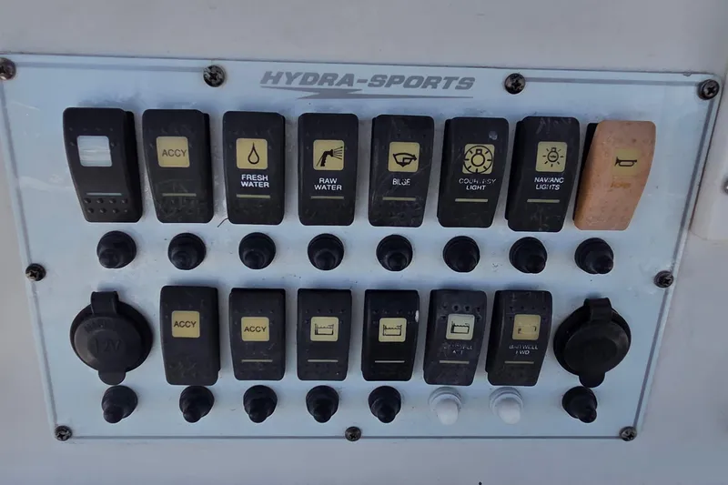 Slide: The Image of Control panel of a 2008 Hydra-Sports Bay Bolt 23 boat with various switches. - 8