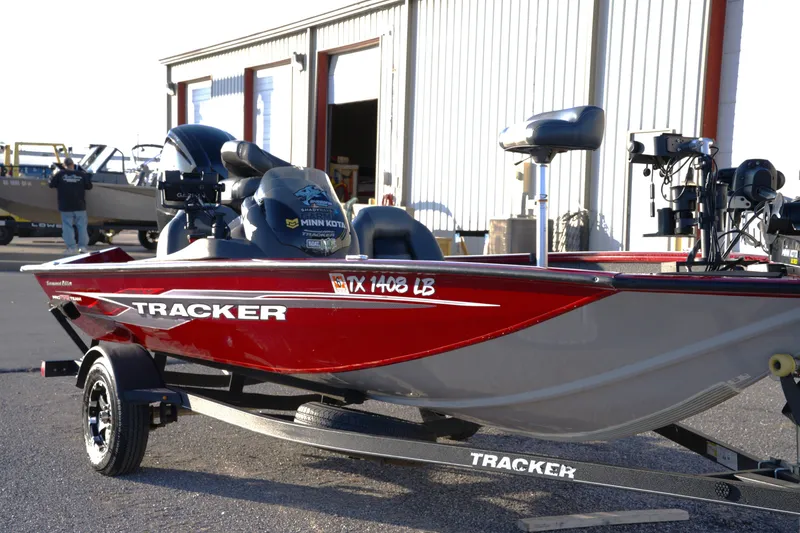 The Image of 2020 Tracker Pro Team 175 TXW Tournament Edition boat on trailer, parked outside a building. - 0