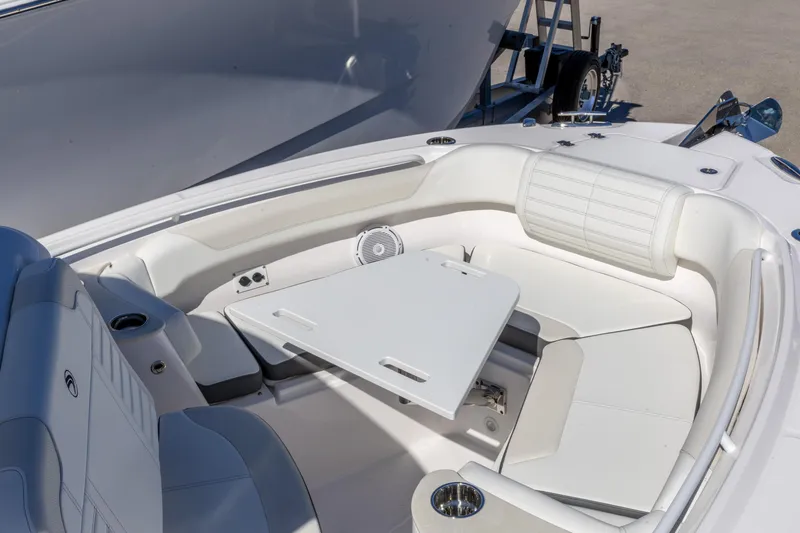 Slide: The Image of Luxurious seating area on 2026 Edgewater 262CC boat with white upholstery and table. - 10
