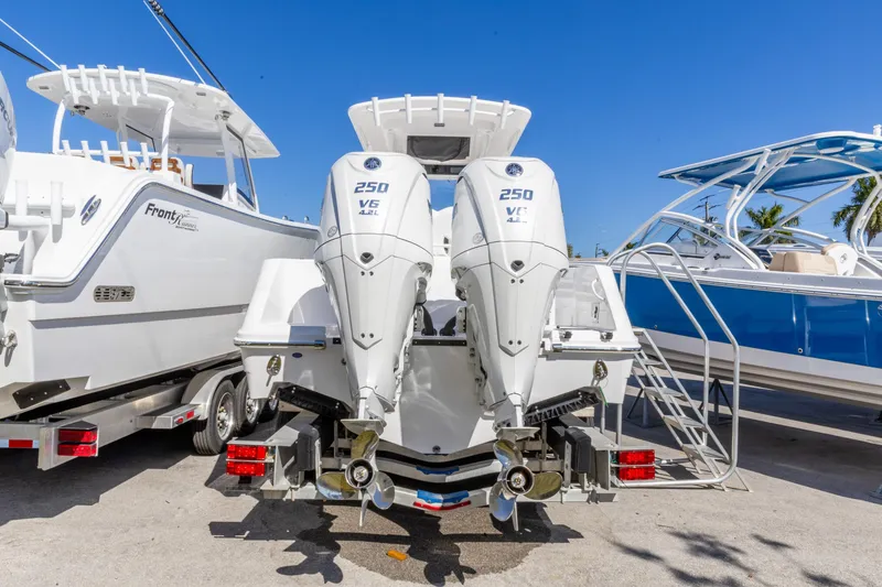 Slide: The Image of 2026 Edgewater 262CC boat with dual 250 V6 engines, parked on a trailer. - 13