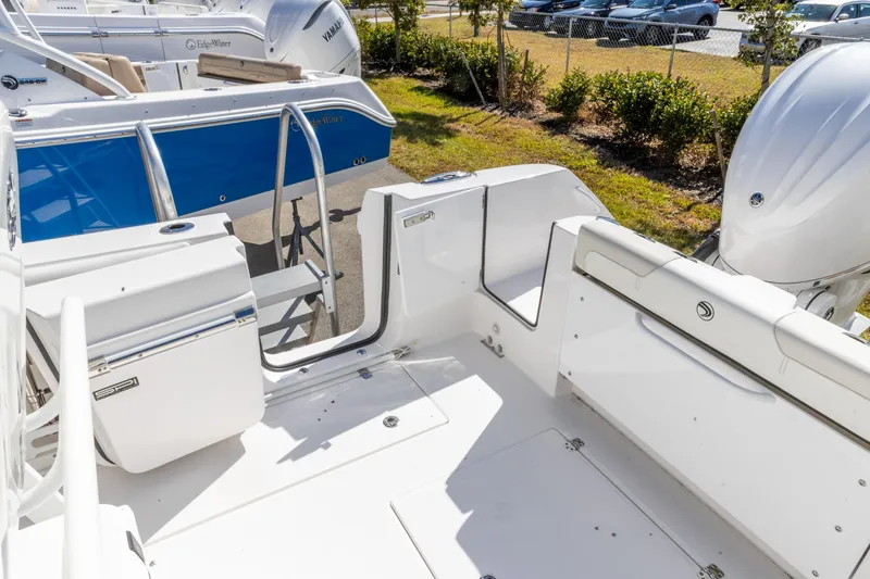 Slide: The Image of 2026 Edgewater 262CC boat interior with seating and outboard motor. - 14