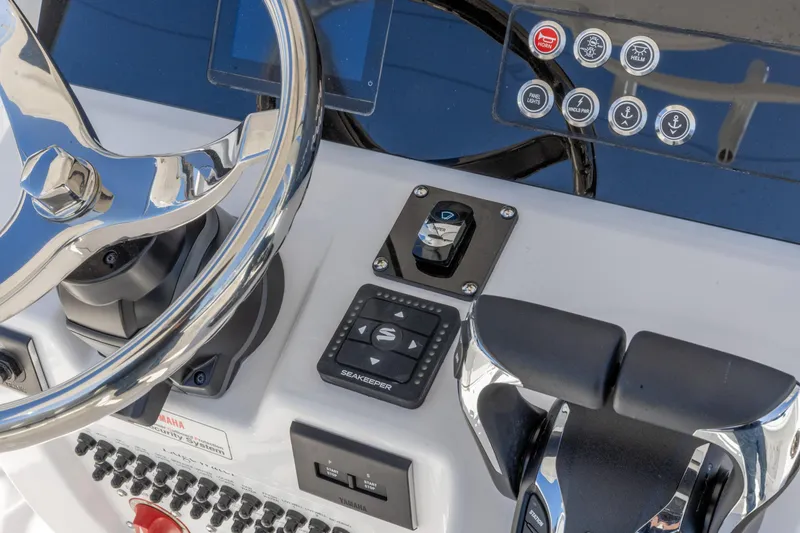 Slide: The Image of Edgewater 262CC 2026 boat dashboard with steering wheel and control panel. - 17