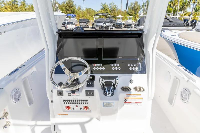 Slide: The Image of 2026 Edgewater 262CC boat dashboard with steering wheel and control panel. - 2