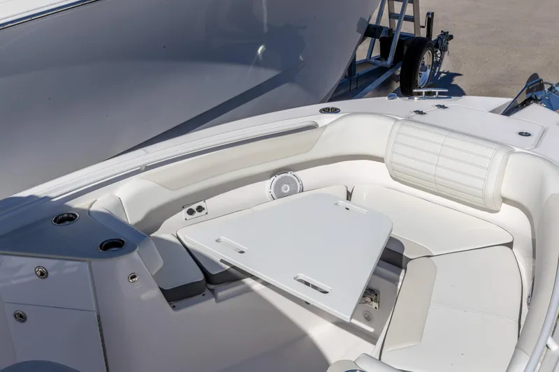 Slide: The Image of 2026 Edgewater 262CC boat interior with white seating and table, showcasing luxury design. - 24