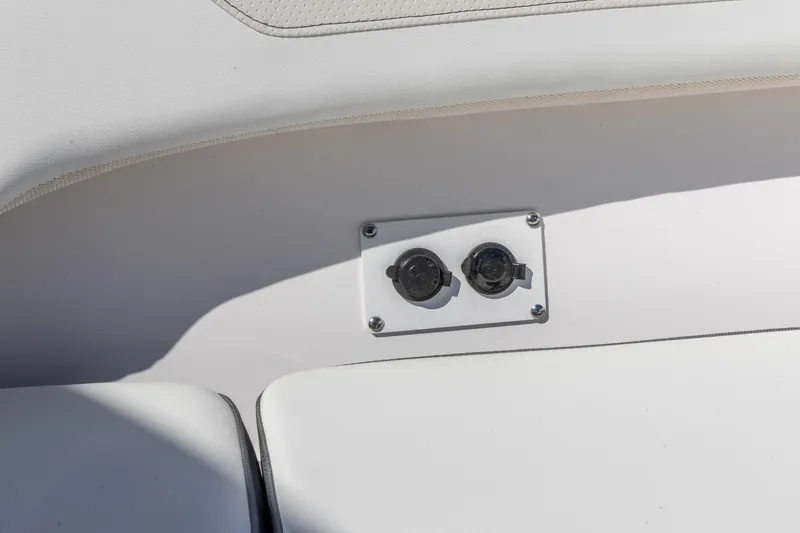 Slide: The Image of 2026 Edgewater 262CC boat interior detail with dual power outlets. - 25