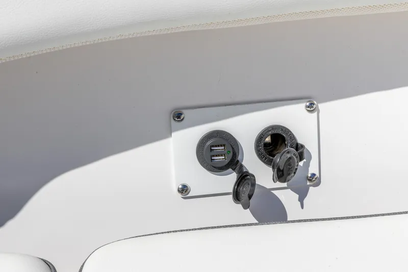 Slide: The Image of 2026 Edgewater 262CC boat USB and power outlets on white panel. - 26