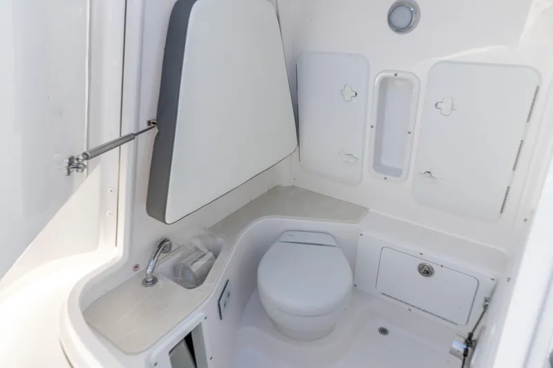 Slide: The Image of 2026 Edgewater 262CC boat interior bathroom with toilet and sink. - 3