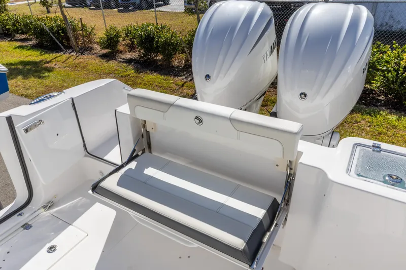 Slide: The Image of 2026 Edgewater 262CC boat with dual outboard engines and foldable seating. - 4