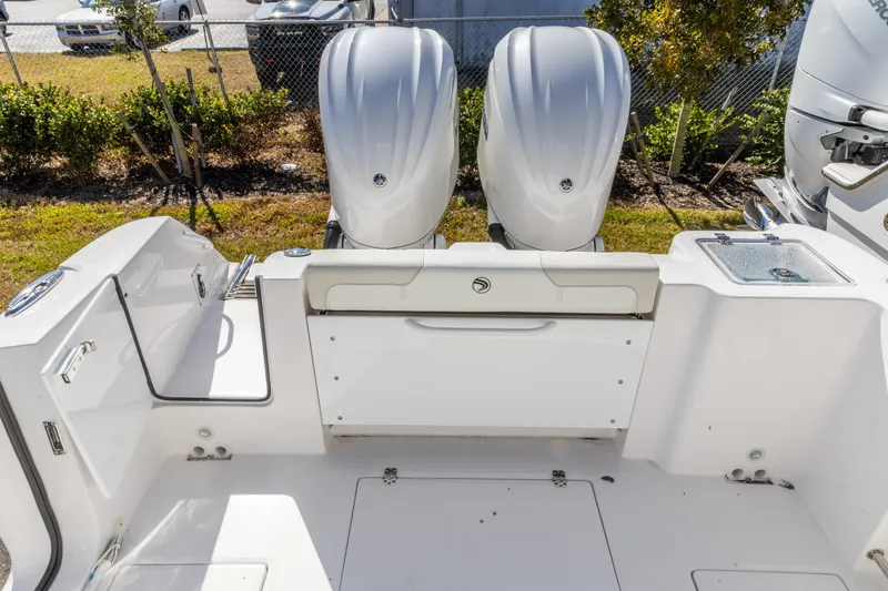 Slide: The Image of 2026 Edgewater 262CC boat with dual outboard engines, rear seating, and clean deck layout. - 7