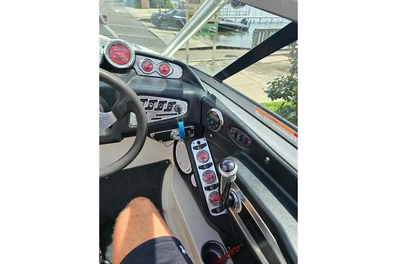 Slide: The Image of 2006 MasterCraft X-45 boat dashboard with gauges and controls, dockside view. - 4