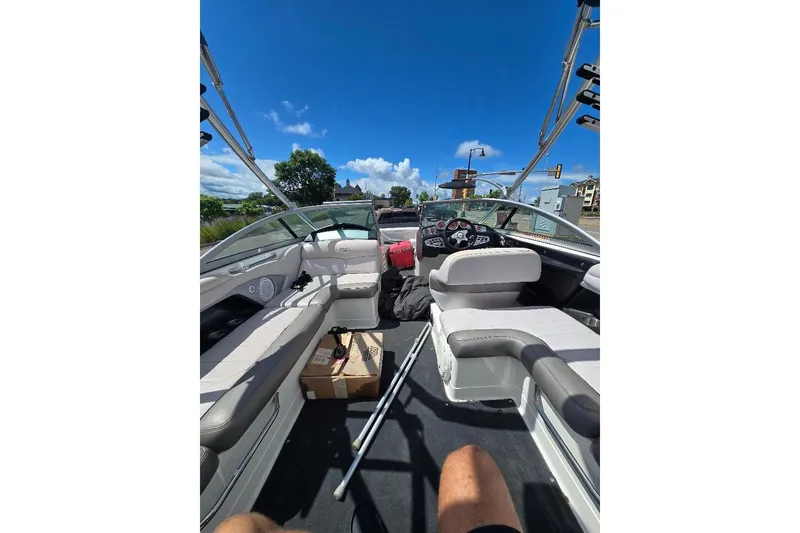 Slide: The Image of 2006 MasterCraft X-45 boat interior with seating and dashboard under clear blue sky. - 5