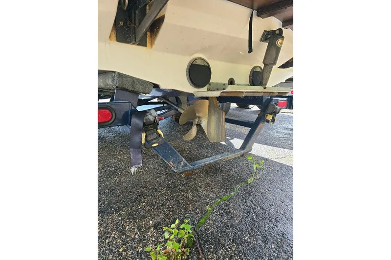 Slide: The Image of 2006 MasterCraft X-45 boat trailer with propeller and straps on wet pavement. - 6