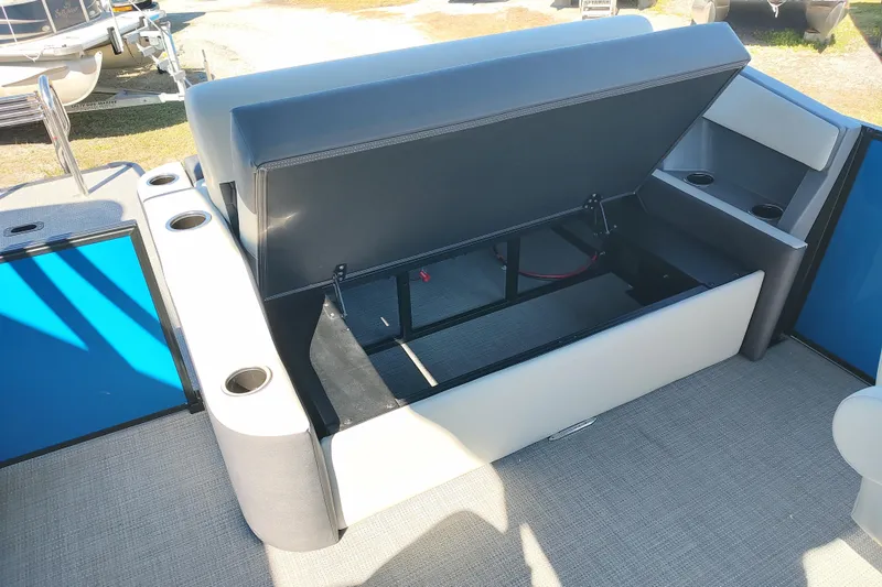 Slide: The Image of 2026 Sylvan R-22 boat interior with open storage compartment and cup holders. - 14