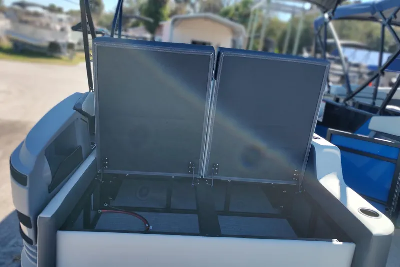 Slide: The Image of 2026 Sylvan R-22 boat storage compartment with open hatch, showcasing interior space. - 17