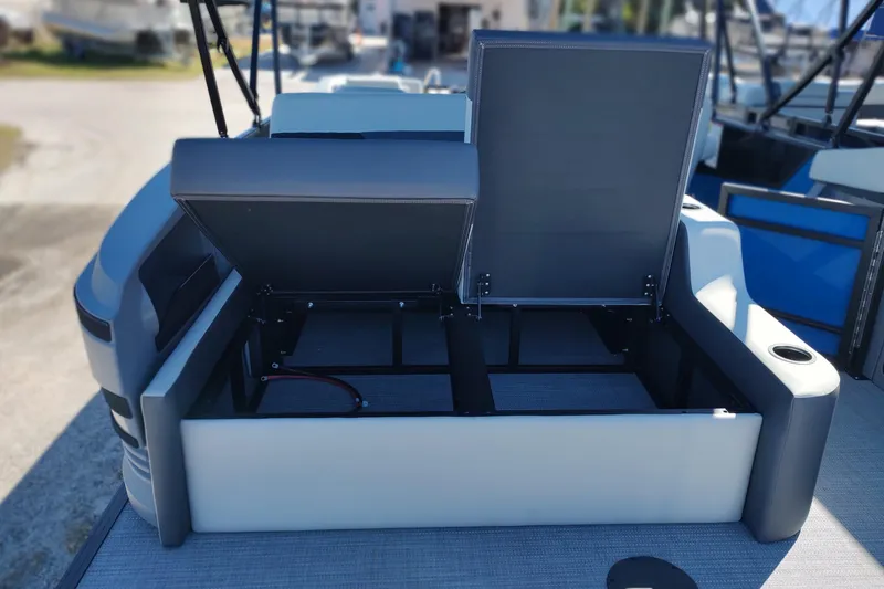 Slide: The Image of Open storage compartment on 2026 Sylvan R-22 boat, featuring modern seating design. - 19