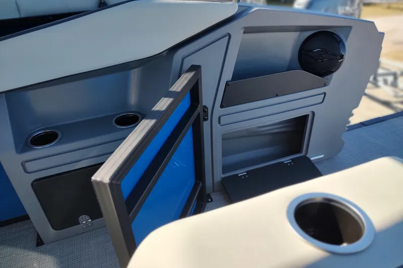 Slide: The Image of 2026 Sylvan R-22 boat interior with open storage compartments and cup holders. - 21