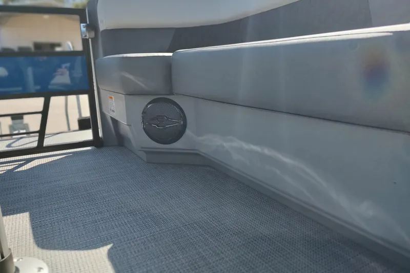 Slide: The Image of Interior of 2026 Sylvan R-22 boat with gray seating and speaker detail. - 7