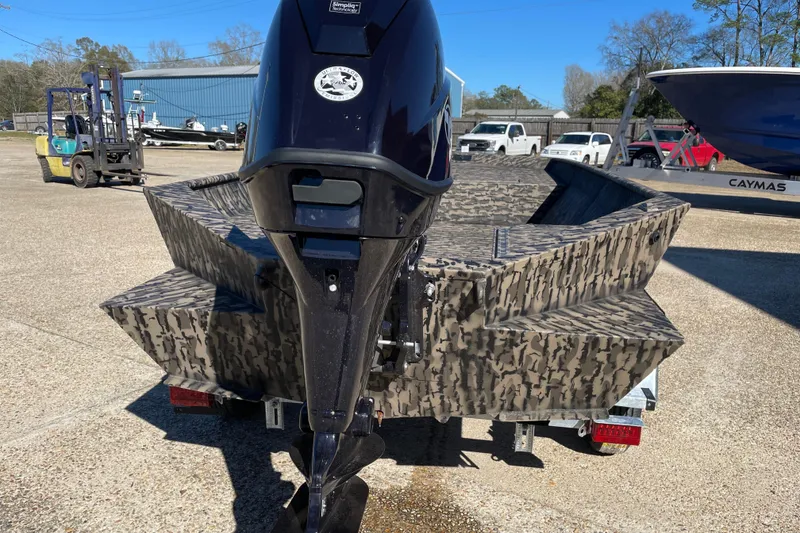 Slide: The Image of 2026 Weldcraft 1652 Predator boat with camouflage design and outboard motor. - 3