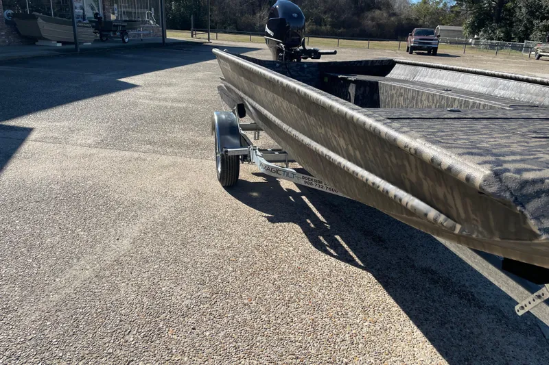 Slide: The Image of 2026 Weldcraft 1652 Predator boat on trailer, parked outdoors in sunny setting. - 4